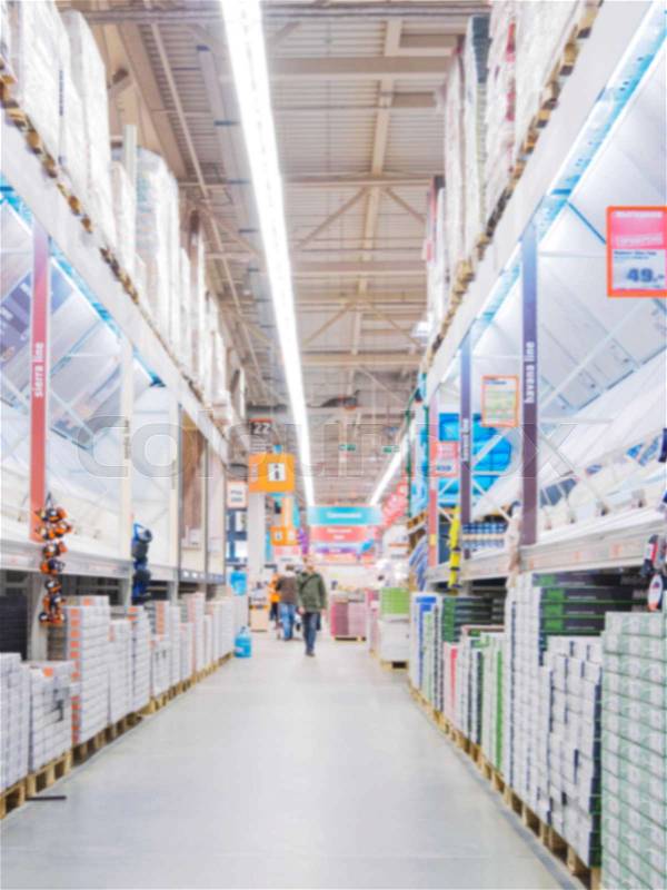 Blurred aisle with finishing materials in hardware store, stock photo