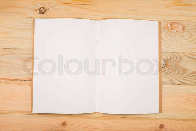 Open new white notebook on the wood background, stock photo