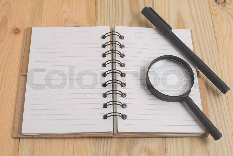 Spiral notebook on wood background, stock photo