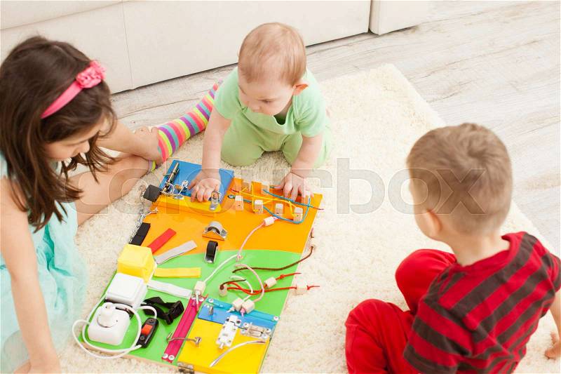 Handmade DIY busy board - sensory children's toy, stock photo