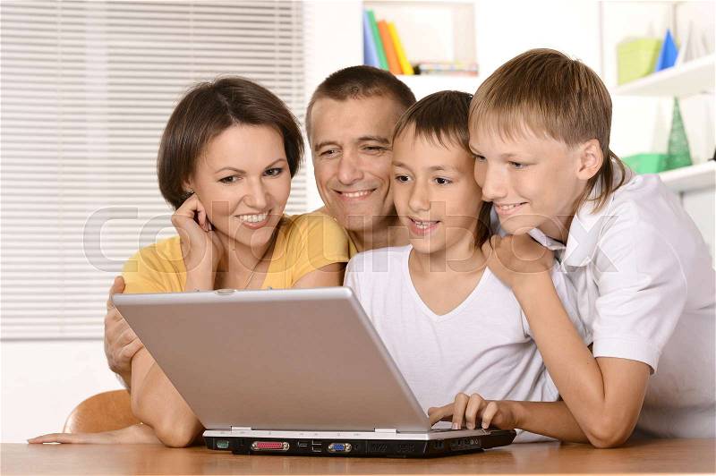 Happy parents with their children spend time at home, stock photo