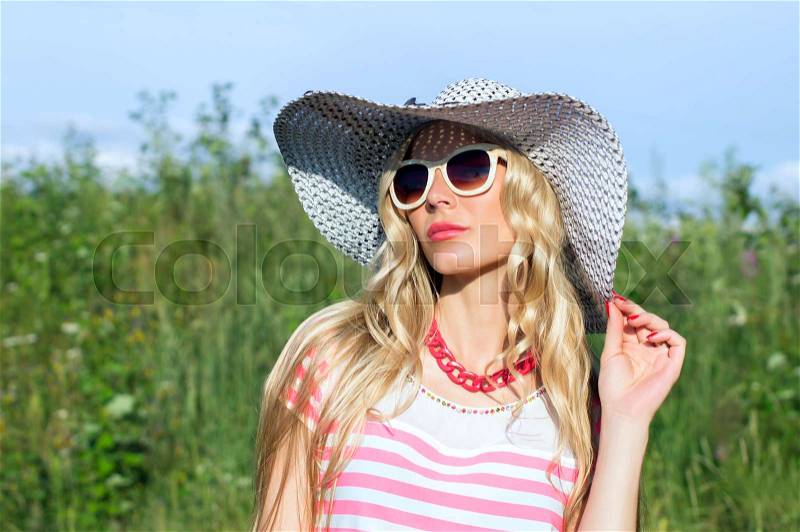 Summer, a girl in a hat sunbathing, stock photo