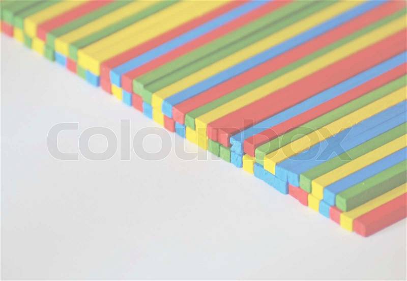 The blue, red, green and yellow wooden sticks, stock photo