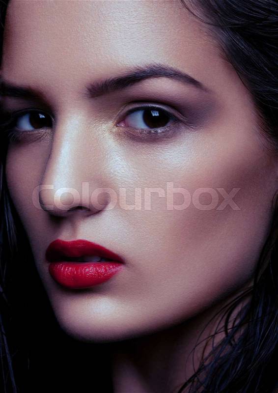Beauty makeup wet hair fashion model with red lips on black background. Dew effect makeup for soft skin, stock photo