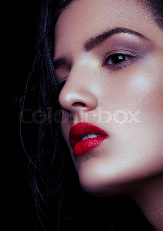 Beauty makeup wet hair fashion model with red lips on black background. Dew effect makeup for soft skin, stock photo