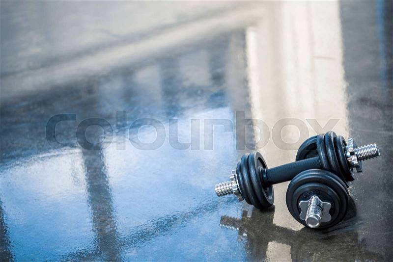 Dumbbells on floor of exercise room, stock photo