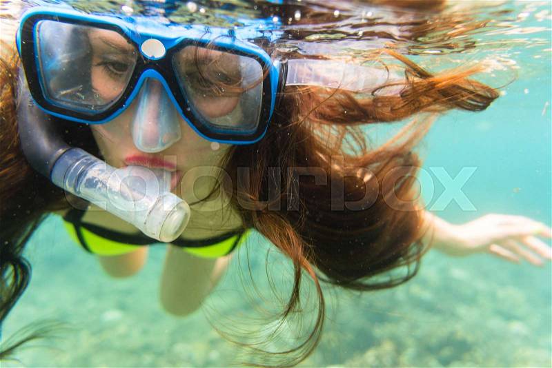 Woman in summer vacation snorkeling in tropical ocean, stock photo