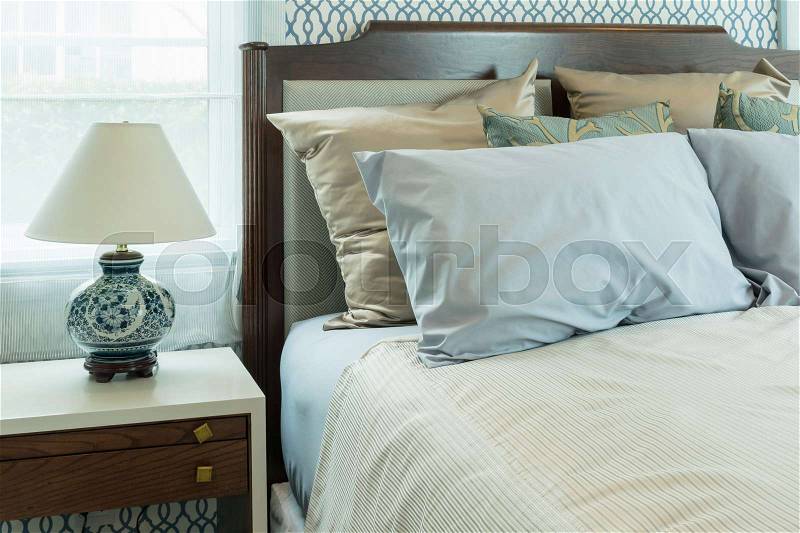 Classic style bedroom with blue pillows and chinese lamp style on bedside table, stock photo