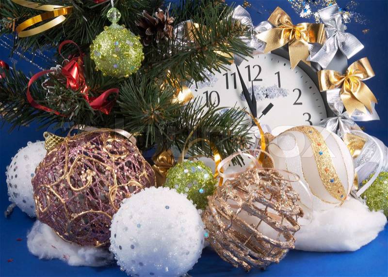 Festive Christmas composition with clock, various holiday balls and other adornments, stock photo