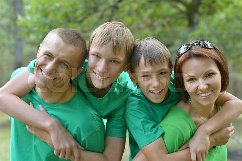 Happy parents with their children spend time outdoors, stock photo