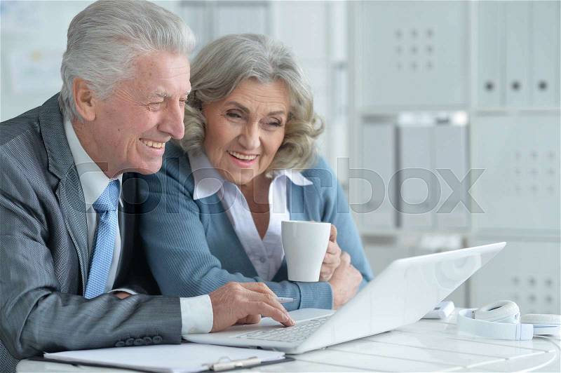 Pair of senior businesspeople working at the office, stock photo
