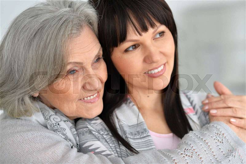 Portrait of a beautiful elderly mother with an adult daughter, stock photo