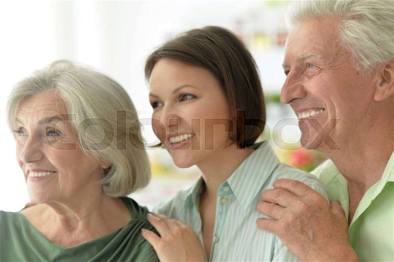 Portrait of elderly parents and their adult daughter, stock photo