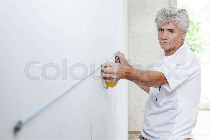 Measuring a wall, stock photo