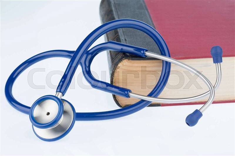 Book and stethoscope, symbol photo for bungling, doctors errors and expertise, stock photo