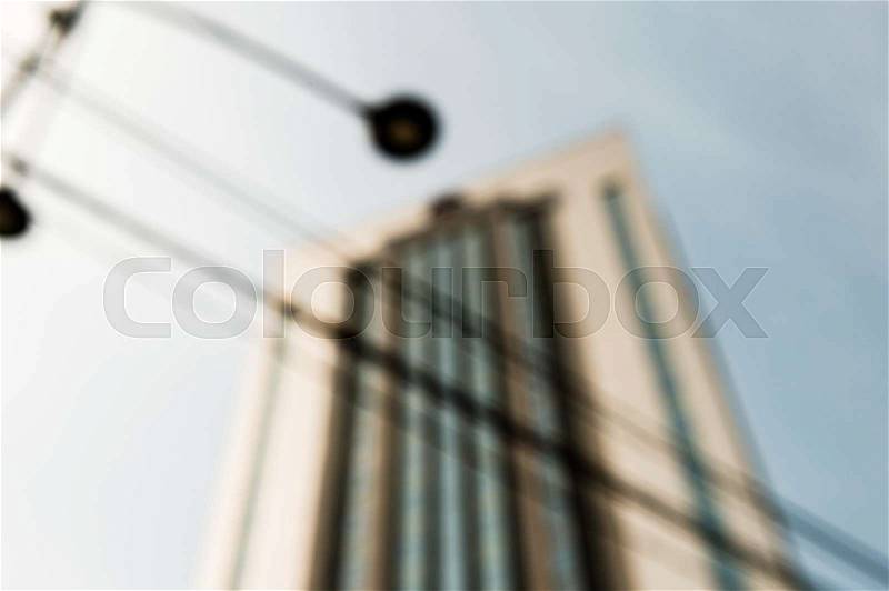 Defocused view of immense hotel building and street light, stock photo
