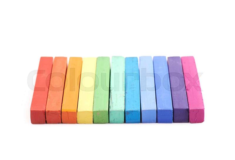 Rainbow gradient made of pastel crayon chalks isolated over the white background, stock photo