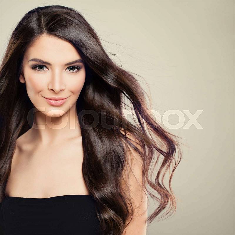 Perfect Young Woman with Blowing Hair. Beautiful Model with Hairstyle and Makeup, stock photo