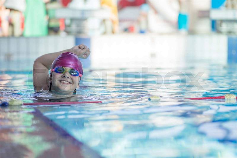 Young and successful swimmers pose in swimming pool, stock photo