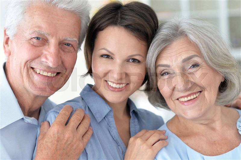 Portrait of elderly parents and their adult daughter, stock photo