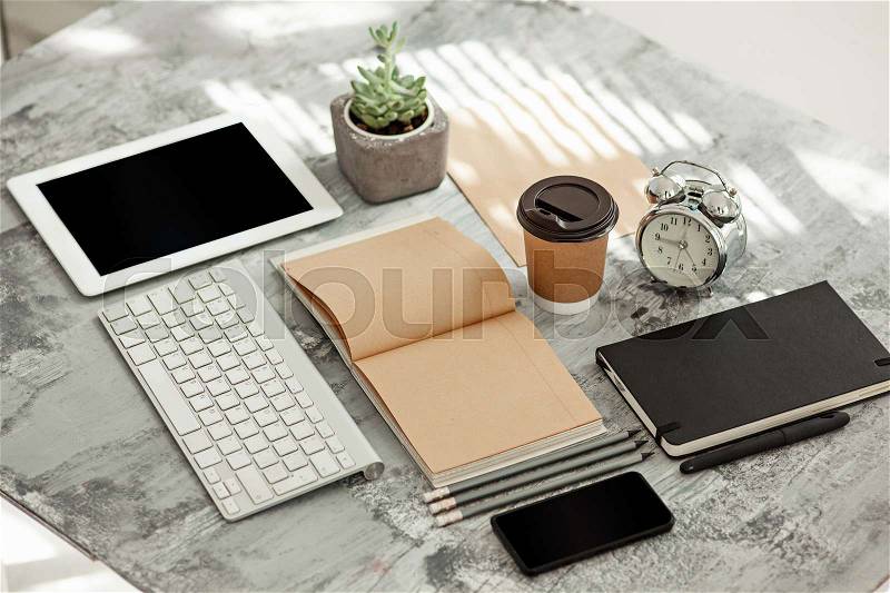 Office desk table with computer, supplies and mobile phone, stock photo