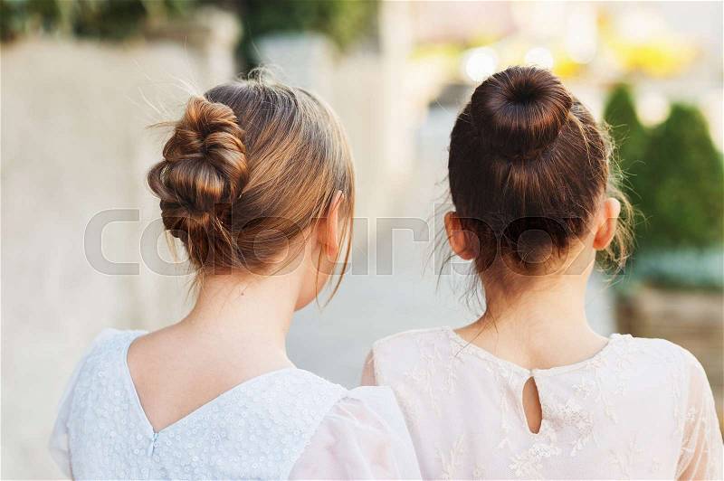 Back view of two little girls with beautiful hairpiece style, stock photo