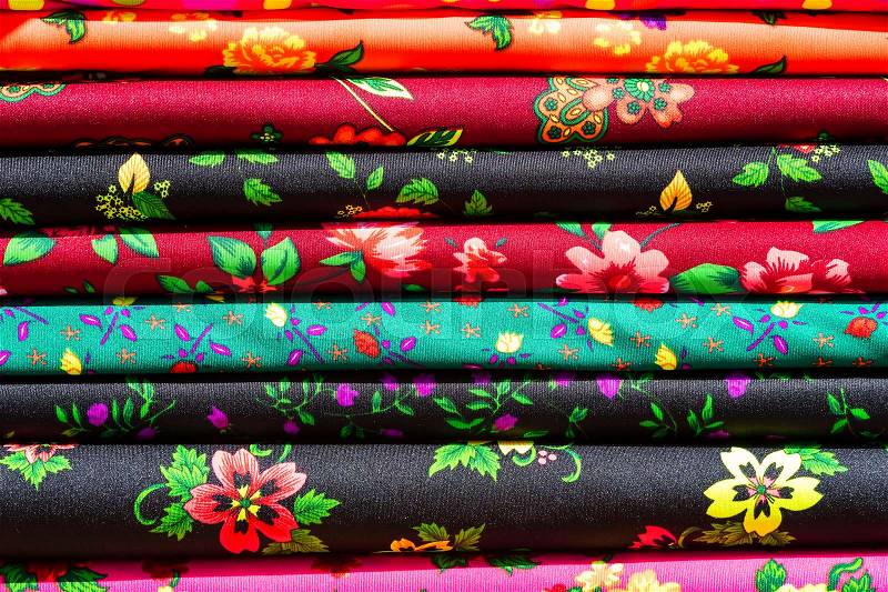 Background of the scrolls rolls colored colorful fabric, stock photo