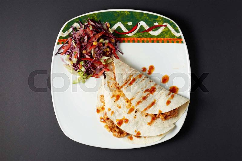 Burrito. Mexican food. Mexican cuisine. Studio shot on dark or black background, stock photo