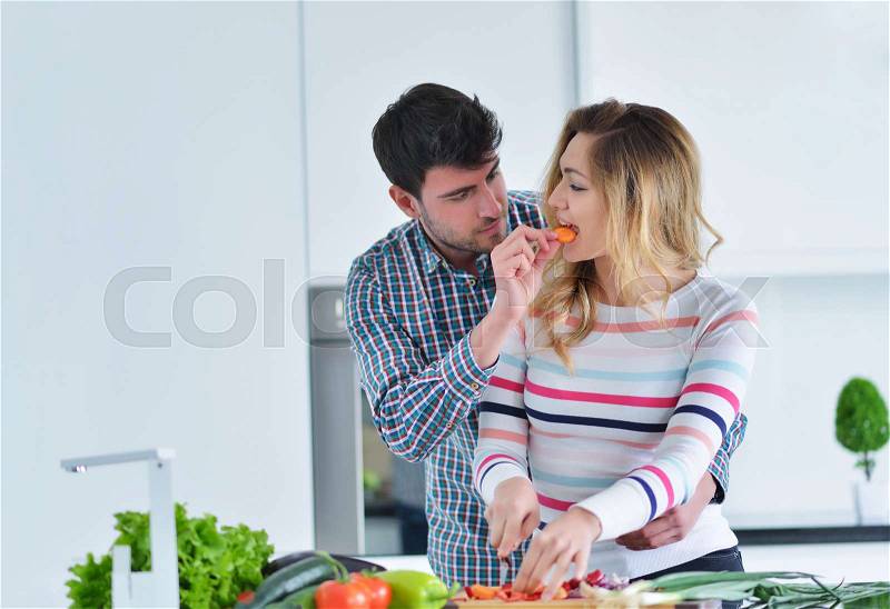 Couple cooking healthy food in kitchen lifestyle meal preparation, stock photo