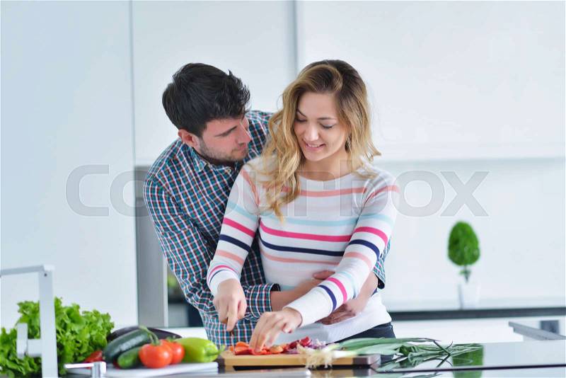 Couple cooking healthy food in kitchen lifestyle meal preparation, stock photo