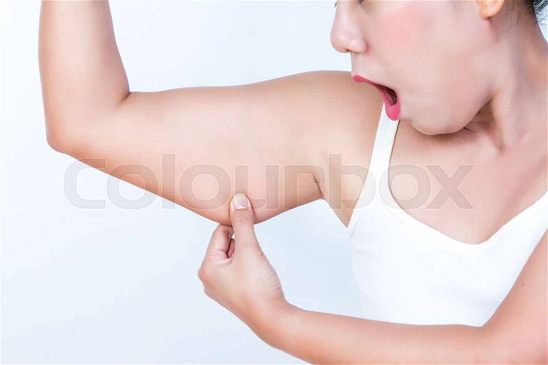 Asian woman checking her upper arm and she agape, stock photo