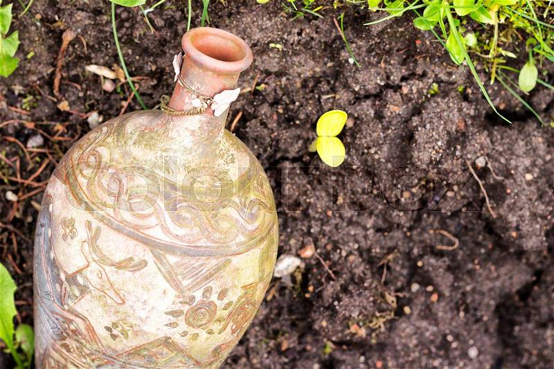 Vintage jug on a ground. Archaeological find, stock photo