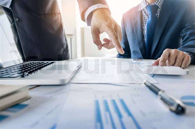 Administrator business man financial inspector and secretary making report, calculating or checking balance. Internal Revenue Service inspector checking document. Audit concept, stock photo