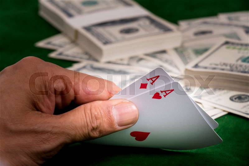 The Hands show chance of winning blackjack game and a pile of dollars on the table at casino , stock photo