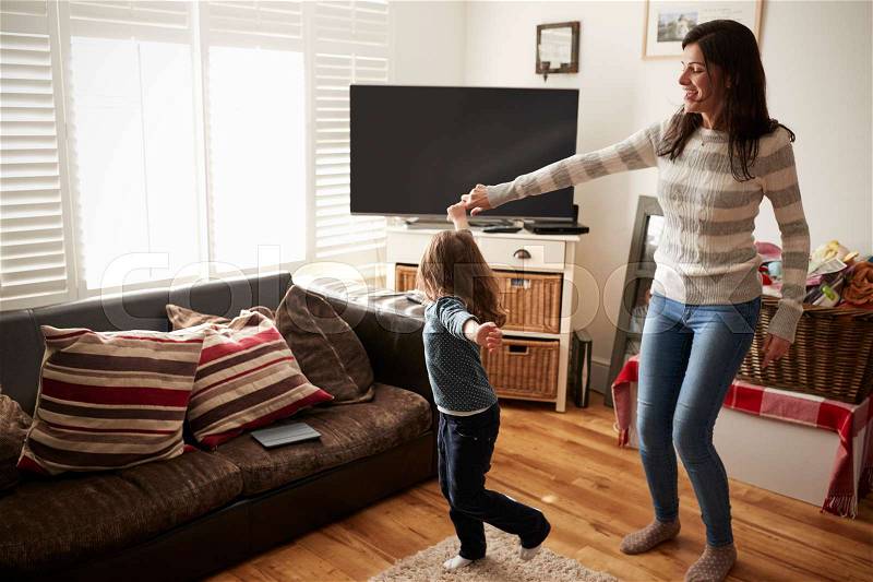 Daughter Dances With Mother At Home, stock photo