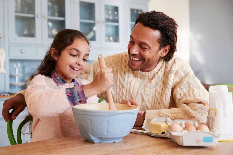 Father And Daughter Baking Cookies At Home Together, stock photo