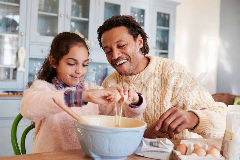 Father And Daughter Baking Cookies At Home Together, stock photo