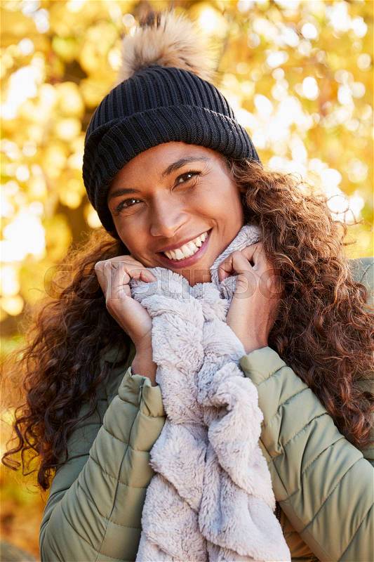 Outdoor Portrait Of Smiling Woman Wearing Scarf In Autumn, stock photo