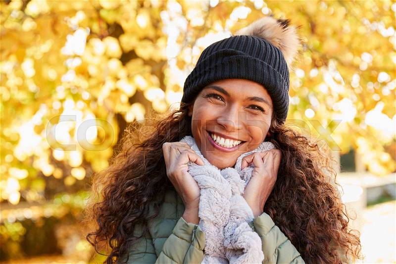 Outdoor Portrait Of Smiling Woman Wearing Scarf In Autumn, stock photo
