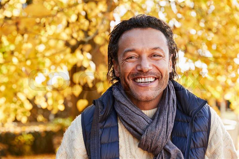 Outdoor Portrait Of Mature Man Wearing Scarf In Autumn, stock photo