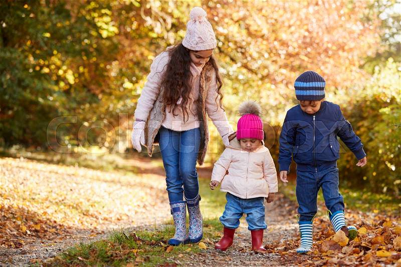 Three Children Enjoying Autumn Countryside Walk Together, stock photo