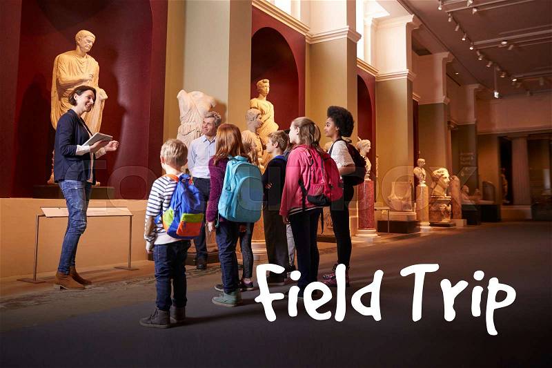 Pupils And Teacher On School Field Trip To Museum With Guide, stock photo