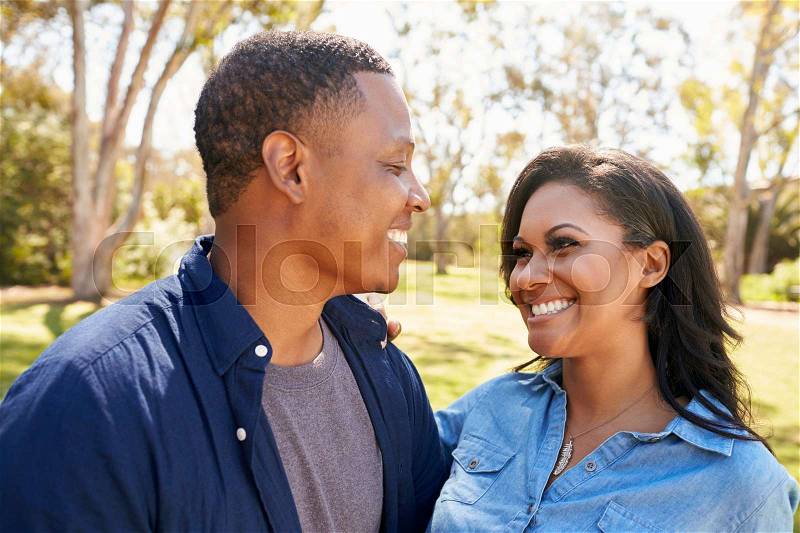 Outdoor Head And Shoulders Shot Of Couple In Park, stock photo