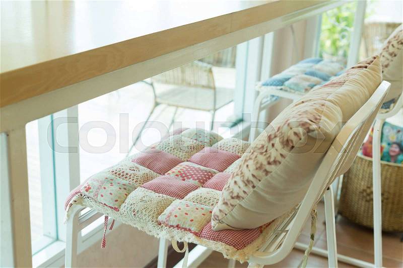 Bar stool with pillow cushion flowers pattern interior decoration in cafe, stock photo