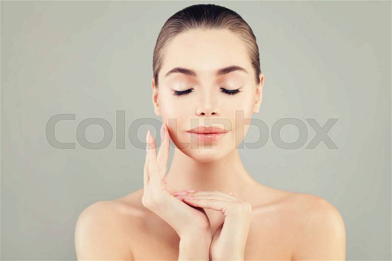 Beautiful Female Model with Healthy Skin and Closed Eyes. Perfect Face and Hand Closeup. Spa Beauty, Facial Treatment and Cosmetology Concept, stock photo