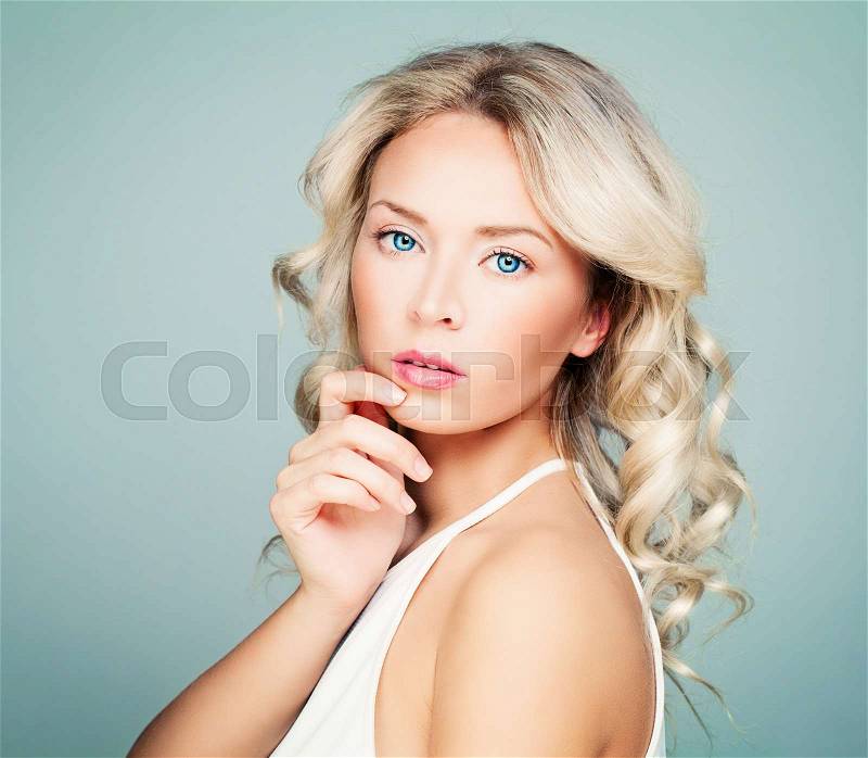 Thinking Model Woman with Healthy Blonde Curly Hairstyle, stock photo