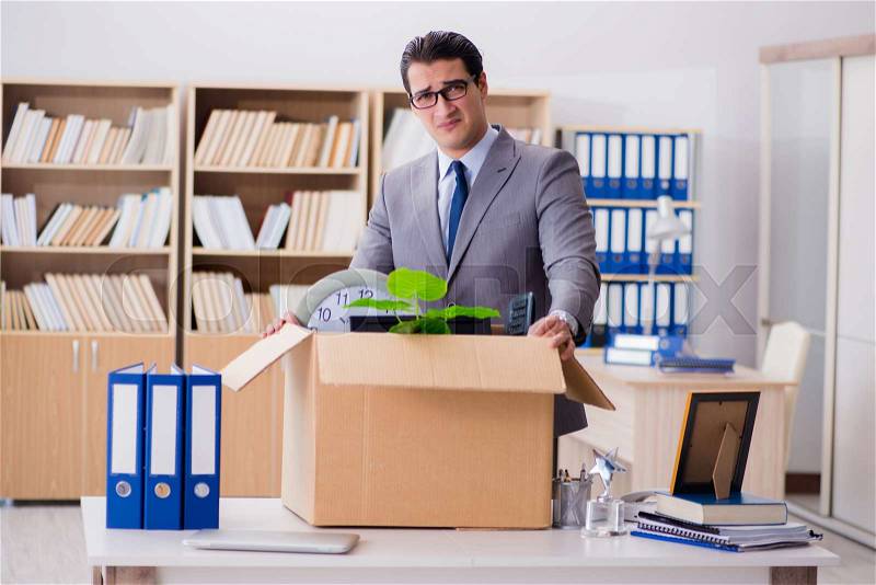 The man moving office with box and his belongings, stock photo