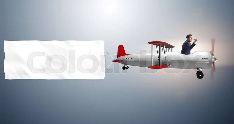 The biplane with businessman and blank banner, stock photo
