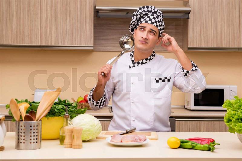 The young chef working in the kitchen, stock photo