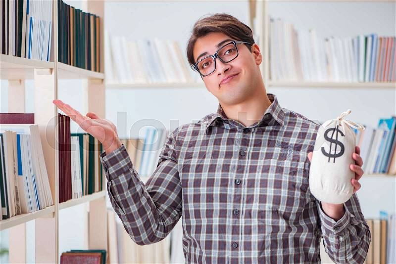 The young student in expensive textbooks concept, stock photo